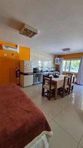 a kitchen and dining room with a table and chairs at Cabañas Amalar in Malargüe