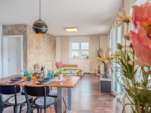 a dining room and living room with a table and chairs at Apartment Franz in Sattendorf