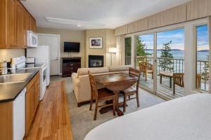 a kitchen and living room with a couch and a table at Rosario Resort in Eastsound