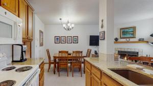 a kitchen with a table and a dining room at Downtown McCall Condo with Balcony & Views in McCall