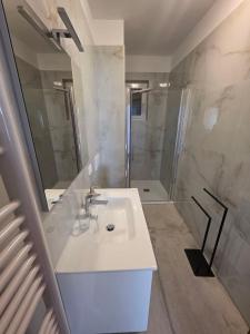 a white bathroom with a sink and a shower at Apartments with parking space Punat, Krk - 5410 in Punat +41 photos