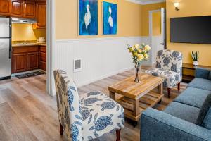 a living room with a couch and chairs and a table at Monterey Bay Lodge in Monterey