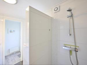 a shower with a glass door in a bathroom at Vogeltrek in Kattendijke +39 photos