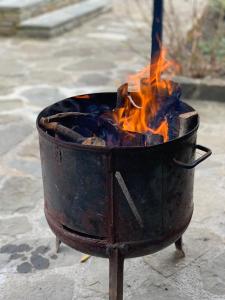 a fire in a pot with flames in it at Vila Tirona in Dardhë