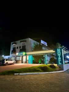 a hotel with a sign in front of it at night at Imperial Hotel in Santa Bárbara