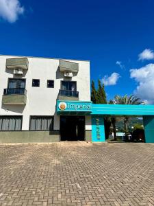 a building with a sign that reads imperial at Imperial Hotel in Santa Bárbara +7 photos