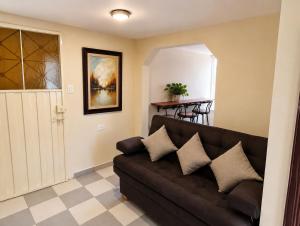 a living room with a brown couch and a table at Apartamento FullLife in Zipaquirá +19 photos