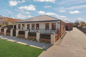 a house in a suburb with a green lawn at Stylish & New 2 Bed & 2 Bath Apartment in Bathurst +12 photos