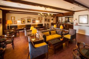 a large room with couches and tables and chairs at Vila Gale Ericeira in Ericeira