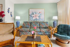 a living room with a couch and chairs and a table at Sugar Beach 304 in Kihei