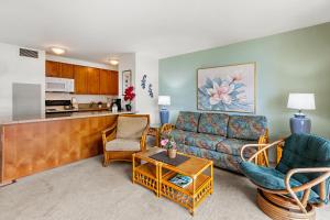 a living room with a couch and chairs and a kitchen at Sugar Beach 304 in Kihei +33 photos