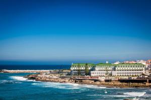 a view of a resort on the beach with the ocean at Vila Gale Ericeira in Ericeira