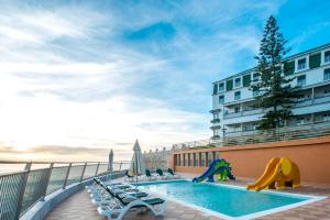 a pool on the balcony of a hotel at Vila Gale Ericeira in Ericeira