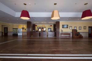 a large empty room with red pendant lights at Vila Gale Ericeira in Ericeira