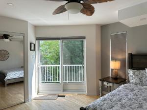 a bedroom with a bed and a large window at Lakehouse Paradise in Val des Monts