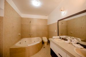 a bathroom with a tub and a sink and a toilet at Yabar Hotel Plaza in Cusco +36 photos