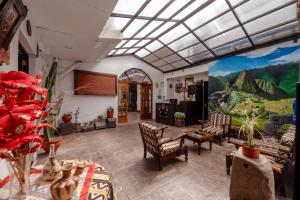 a living room with a painting on the wall at Yabar Hotel Plaza in Cusco
