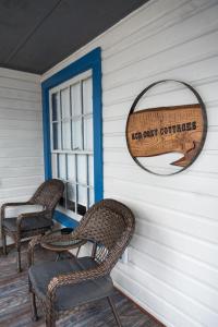 two wicker chairs sitting on a porch with a window at "Rustic Getaway A Charming & Cozy Cottage for Two or Four!" in Geneva