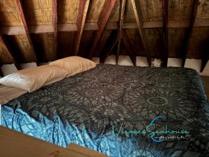 a bed in a yurt with a black comforter at Cozy chill island roundhouse magic 2 miles from beach-The Vieques Seahouse in Moscou