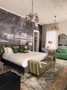 a bedroom with a large bed and a couch at Auberge McGowan in Austin