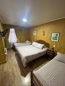a hotel room with two beds and a window at HOTEL CASAGRANDE con estacionamiento EXCLUSIVO y estamos a 50 MTS del Terminal de Buses in Valdivia