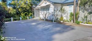 a driveway in front of a house at The Boathouse a 3 Bedroom Holiday Home in Narooma