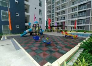 a playground with a slide in a courtyard at Davao city One Lakeshore Drive at the back of sm lanang in Davao City