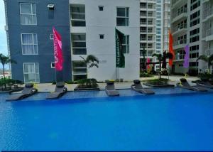 a large swimming pool with blue water in front of buildings at Davao city One Lakeshore Drive at the back of sm lanang in Davao City