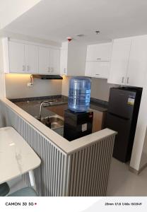 a kitchen with a large bottle of water on the counter at Davao city One Lakeshore Drive at the back of sm lanang in Davao City