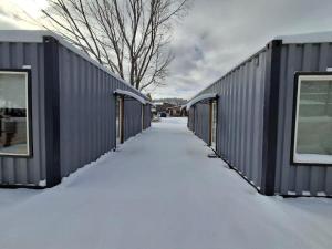 a row of storage containers covered in snow at Caminante in Creel