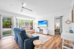 a living room with a couch and a chair at Renovated 2 Bedroom Ground Level Villa in Noosaville in Noosaville