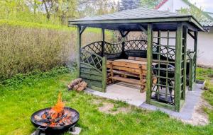 a gazebo with a bench and a fire at Stunning Home In Cybulin With Wifi in Cybulino +10 photos