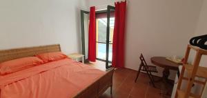 a bedroom with a bed and a desk and a window at Piccolo Paradiso Crotone in Casa Margherita