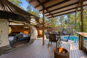 a tent on a deck next to a pool at Tamborine Mountain Glades in Mount Tamborine