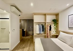 a hotel room with a bed and a closet at Capsula Hotel Sao Paulo - Paulista in São Paulo