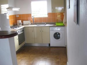a kitchen with a washing machine and a sink at Mon Repos in Sainte-Luce