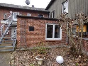a brick building with a staircase and a yard at fewo1846 - Hofzimmer - ländlich gelegene Auszeit für zwei Personen in Handewitt