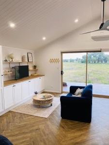 a living room with a couch and a table at Coco's Bungalow in Mudgee