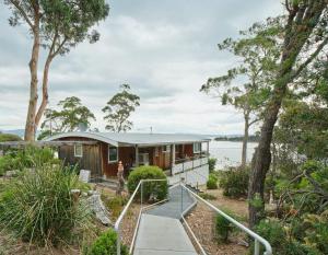 a house on the shore of a body of water at Artist's Beach House - Waterfront in Murdunna
