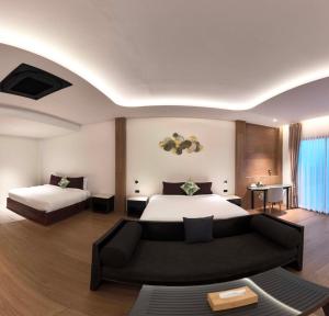 a hotel room with a bed and a couch at Merry Holmes Resort Hatyai in Ban Tha Sae +53 photos