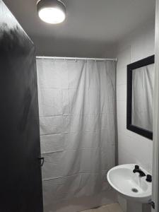 a bathroom with a shower and a sink at La Serenité en Puerto Madryn in Puerto Madryn +9 photos