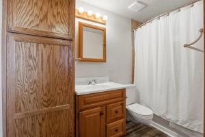 a bathroom with a sink and a toilet and a mirror at Hayden Lake Oasis in Hayden +42 photos