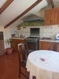 a kitchen with a table and a stove top oven at Casa Zudañes in Sucre