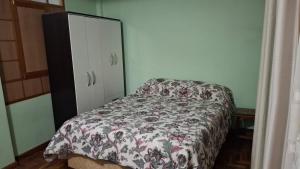 a bedroom with a bed and a dresser at Casa Zudañes in Sucre