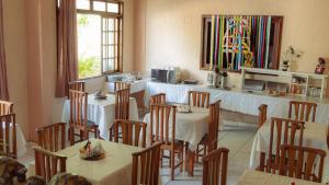 a restaurant with tables and chairs and a counter at Pousada Cabocla - Centro de Alter in Alter do Chao