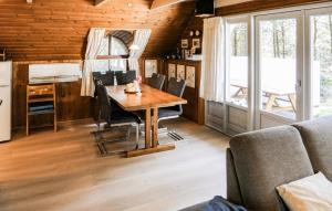a dining room with a table and chairs at Holiday Home Narssagsvej in Rømø