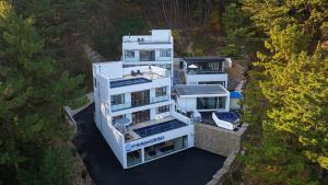 an aerial view of a large white house at Yeongdeok Full Moon Pool Villa in Yŏngdŏk