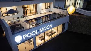 a building with a sign that reads poole moon at Yeongdeok Full Moon Pool Villa in Yŏngdŏk +3 photos