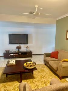 a living room with a couch and a table at Mudgee Gardens Stayz in Mudgee