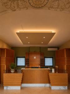 a large room with wooden cabinets and a large ceiling at SMART Hotel Argo in Orzinuovi